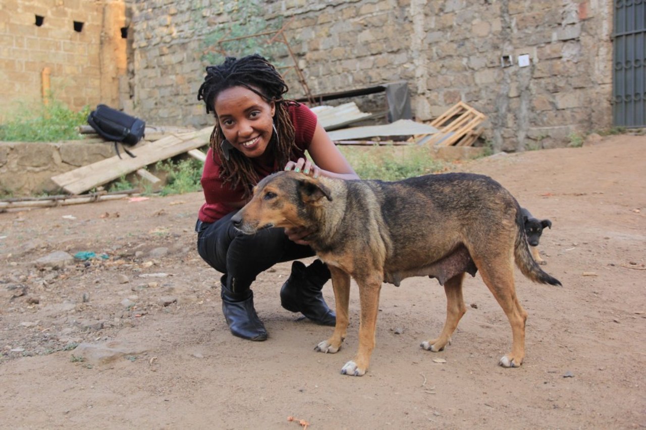 A woman petting her dog, Browny.