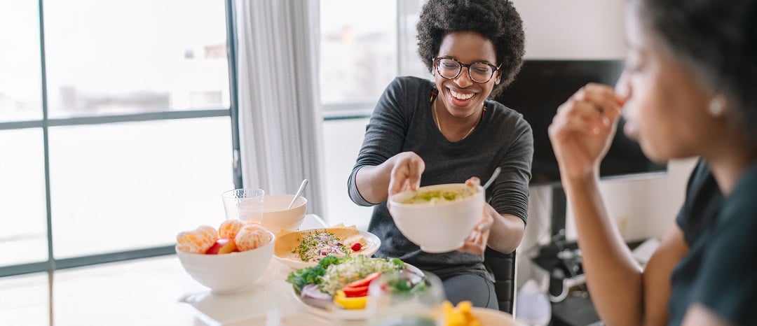 Two people eating plant-based foods