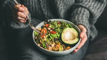 Person eating plant-based bowl