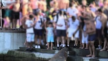 A walrus surrounded by human onlookers