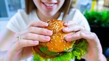 A woman eating a veggie burger