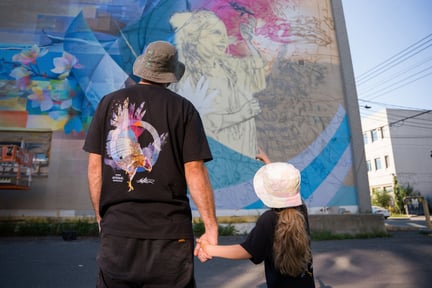 Fluke with his daughter in front of Montreal Mural