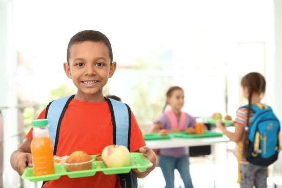 Child holding cafeteria lunch