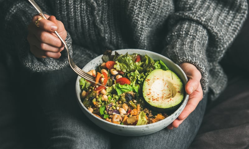 Person eating plant-based bowl