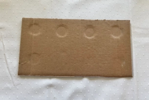 A rectangular piece of cardboard