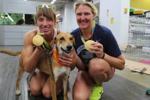 Athena the dog with two Olympic gold medallists at our dog adoption event in Rio