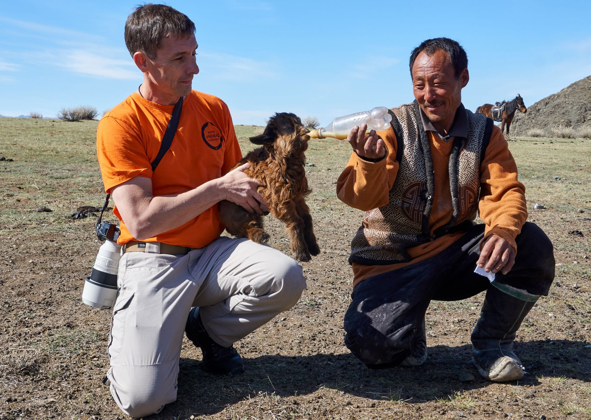 Steven Clegg from our disaster team feeding a baby goat in Mongolia.