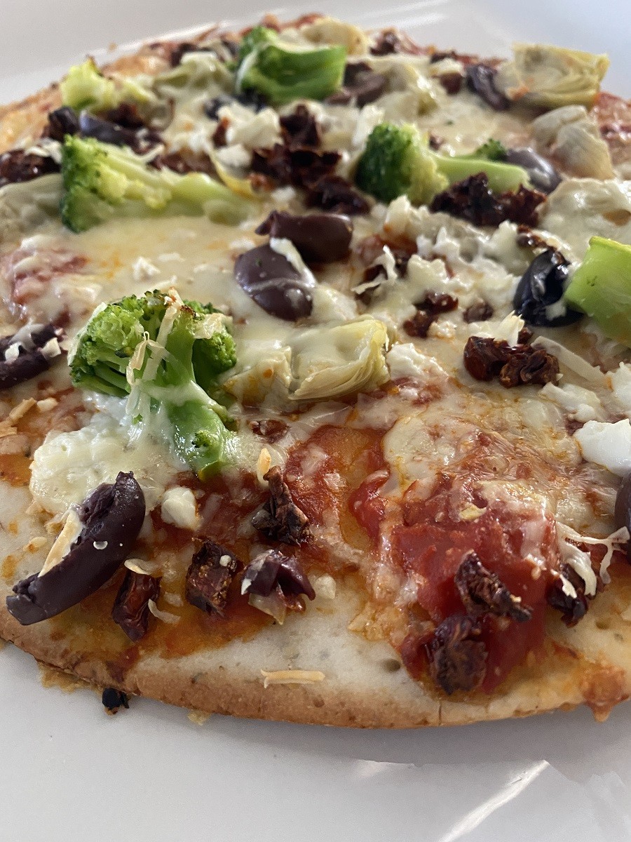 A pizza topped with cheese and vegetables