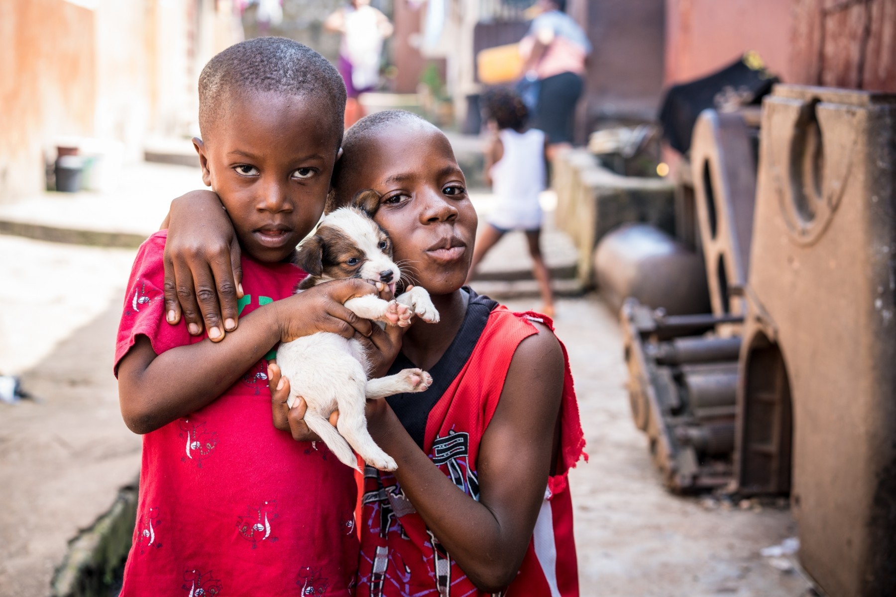 Two children holding small puppy - World Animal Protection